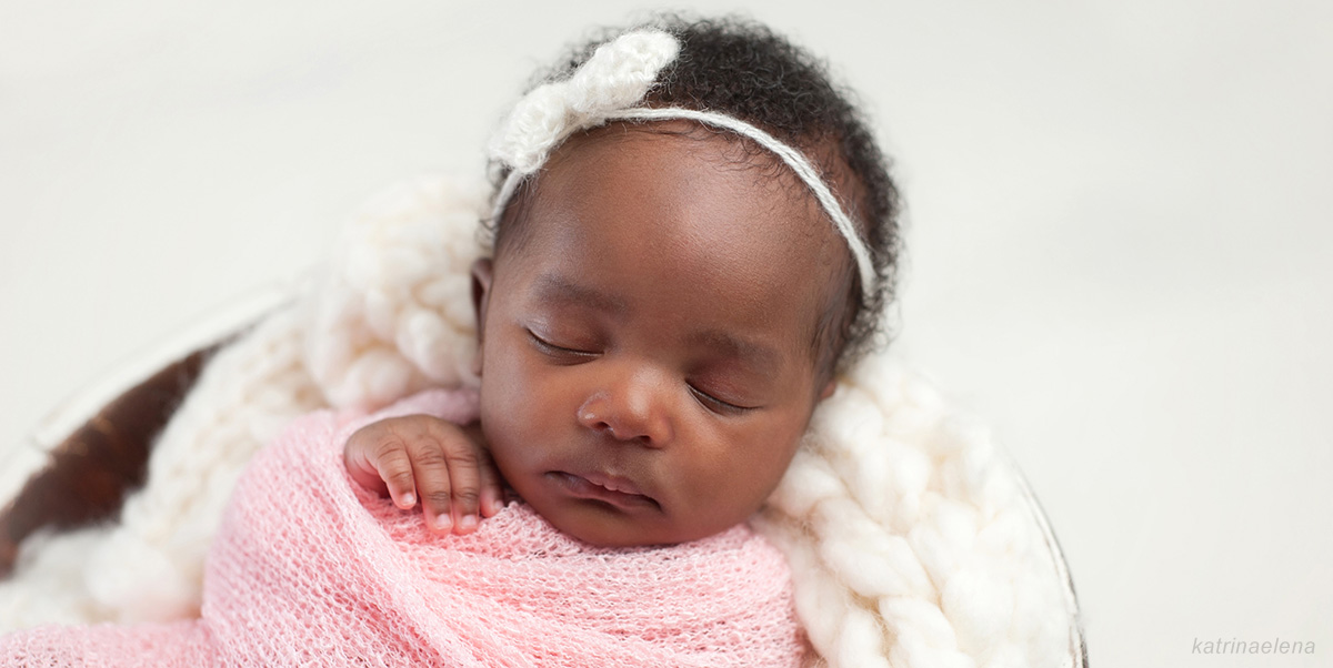 Black-American baby girl in pink headband